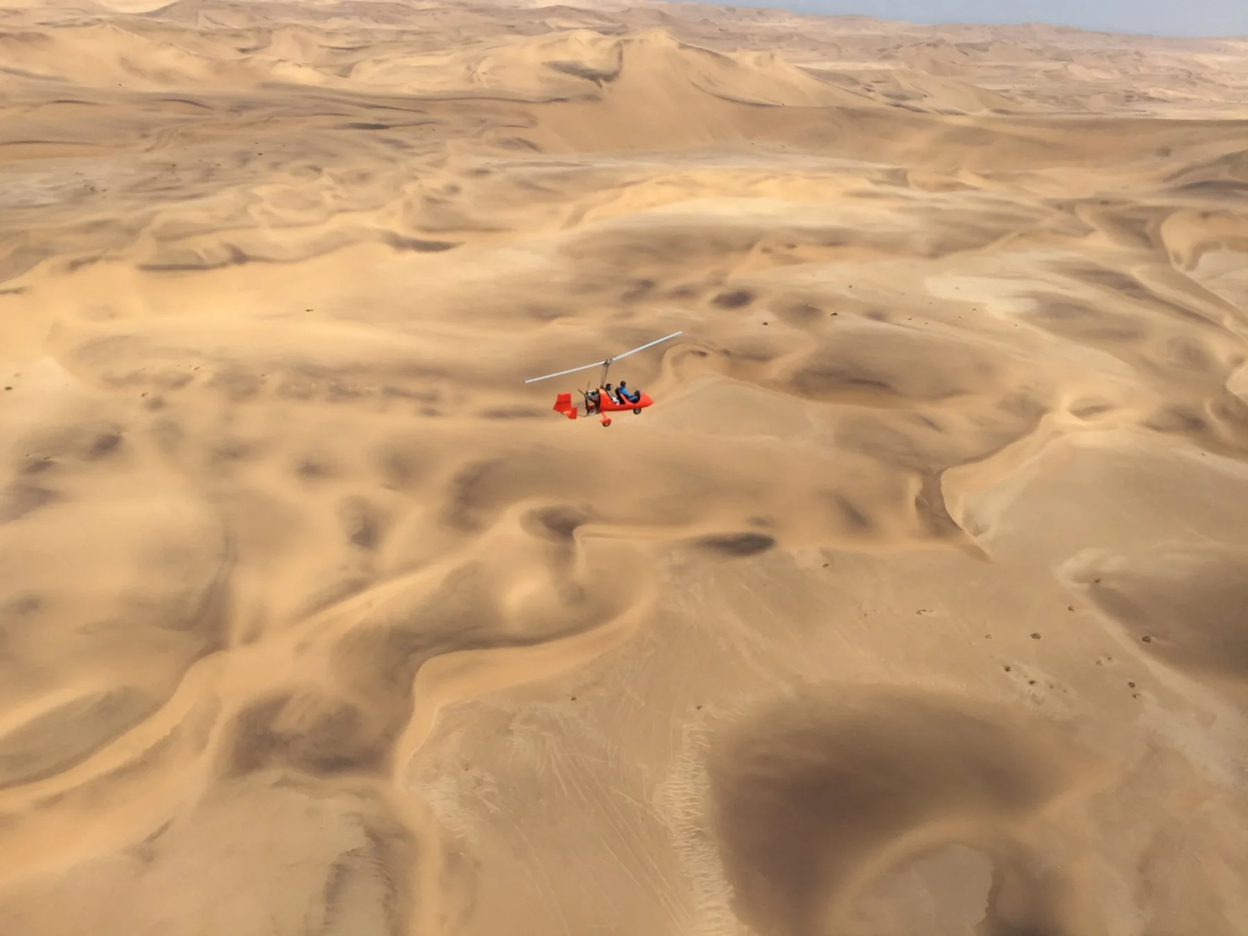 Gyroplane in flight above the Namib dunes
